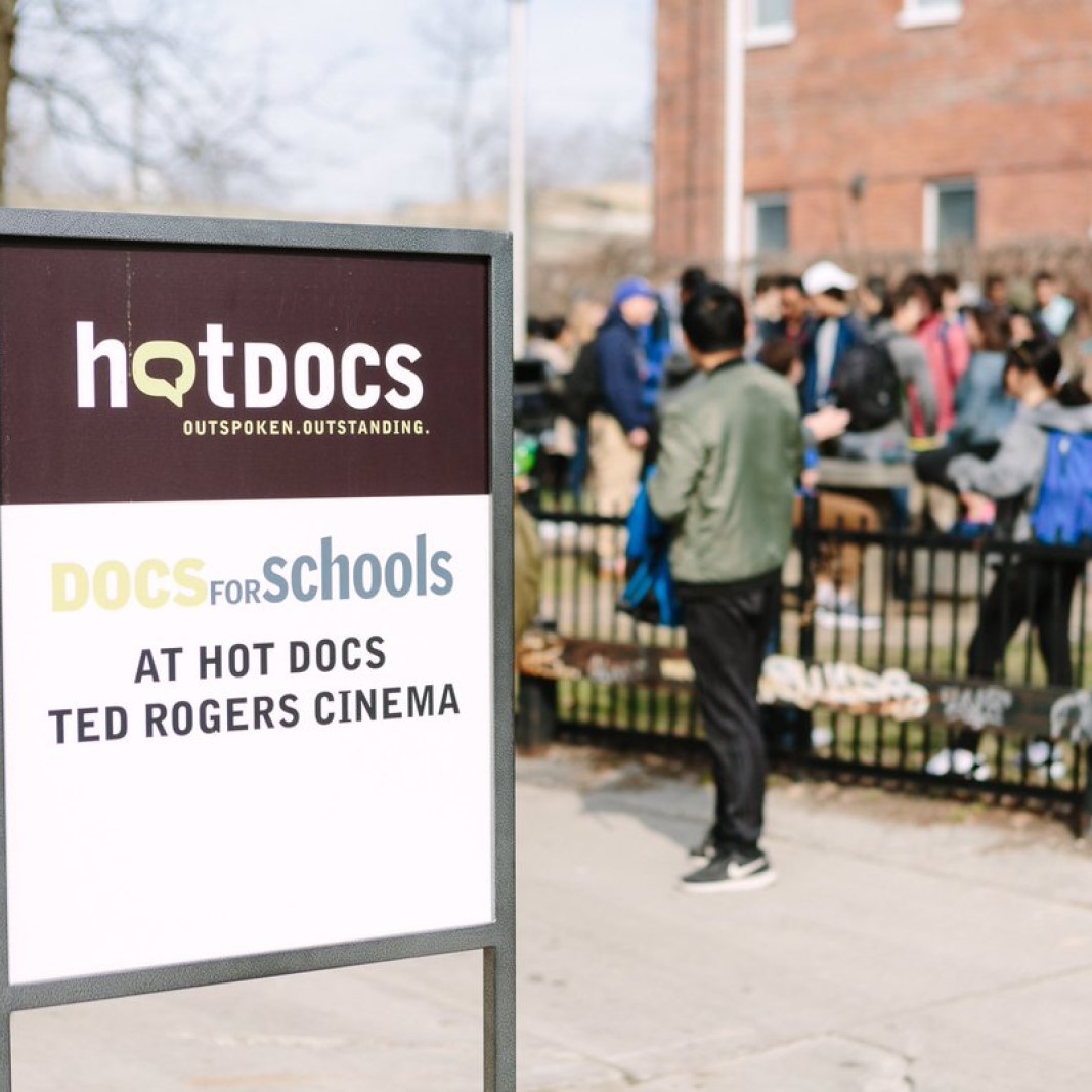 Docs for Schools sign with students