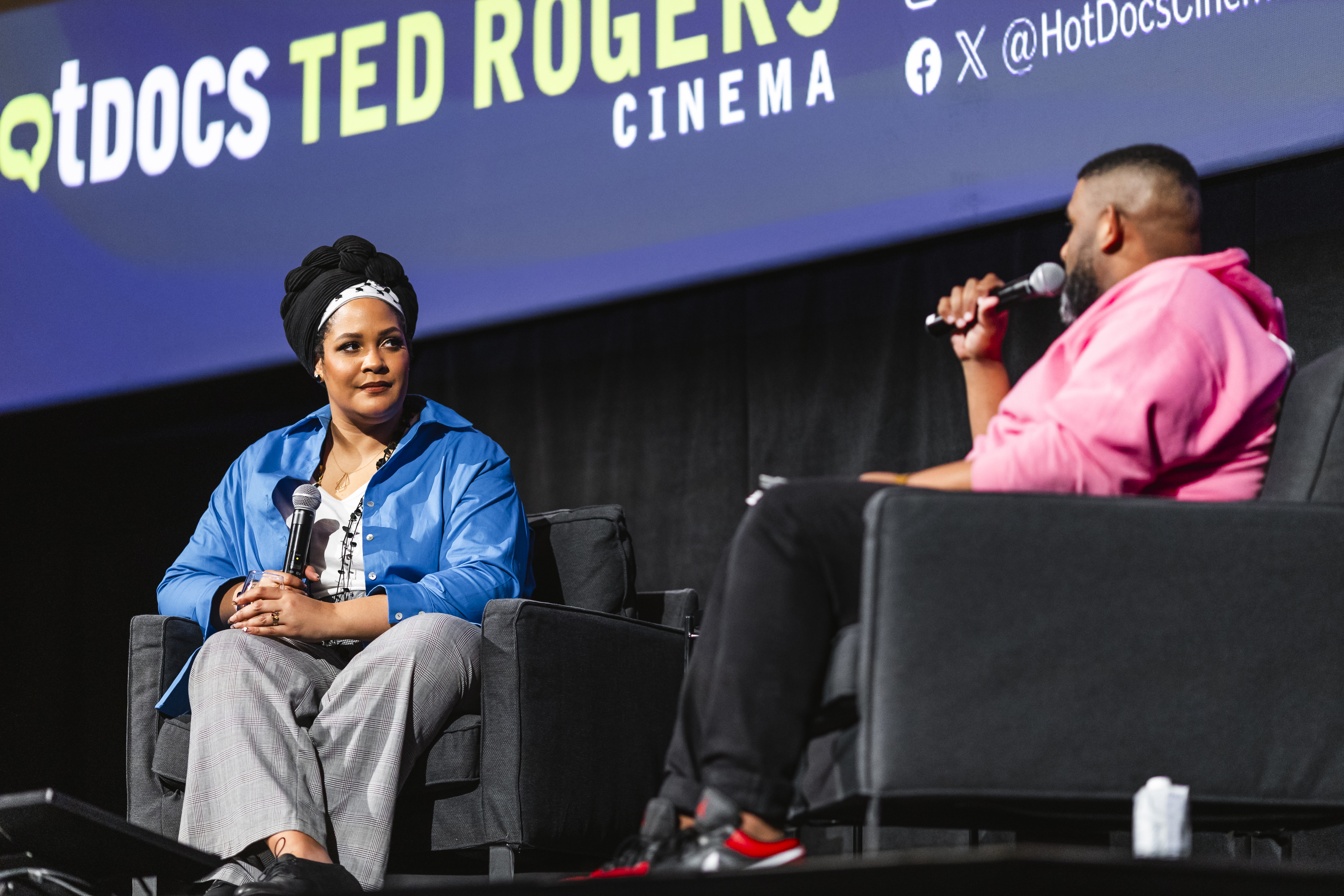 Two speakers seated on-stage at Hot Docs Ted Rogers Cinema