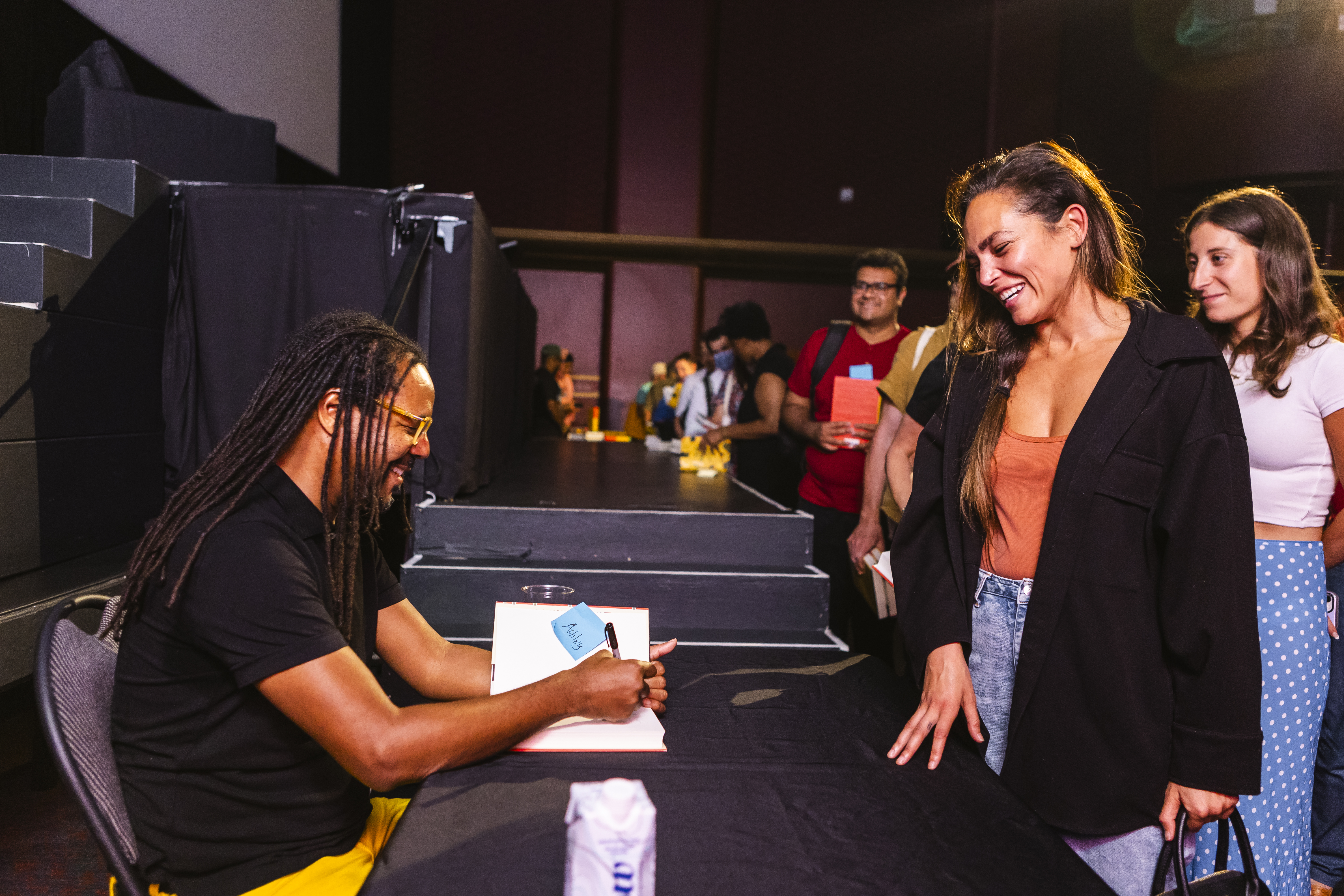 Novelist Colson Whitehead signing books for audience members